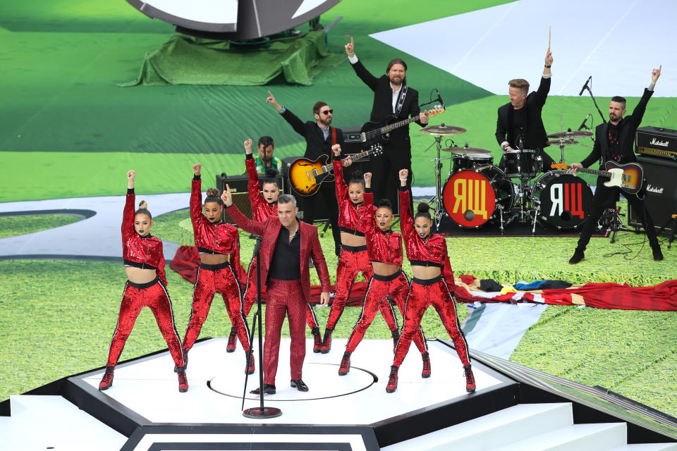 <p>Let him entertain you: Robbie Williams warms up the crowd at the Luzhniki Stadium. (Getty) </p>
