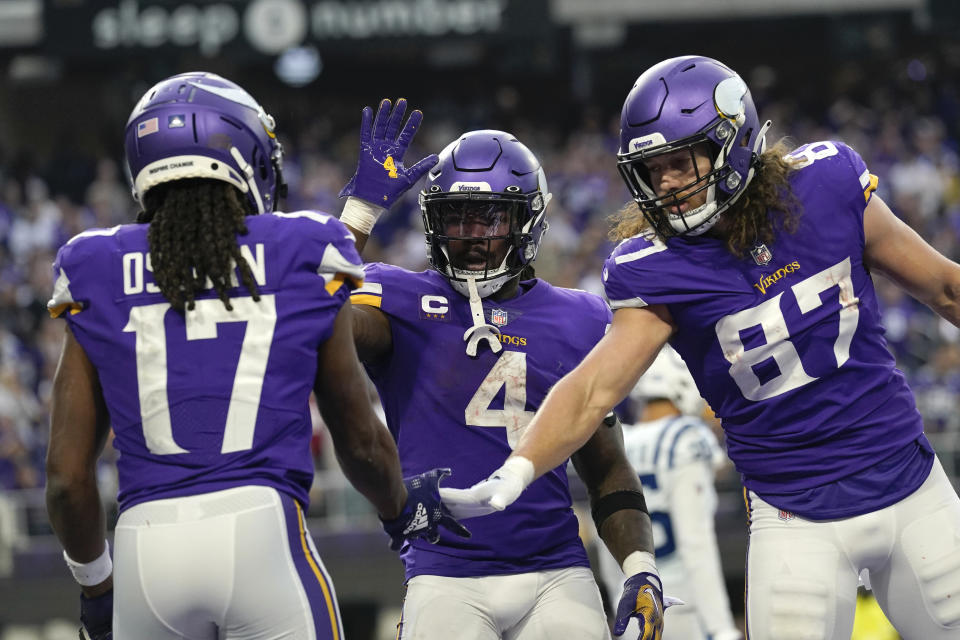 Minnesota Vikings wide receiver K.J. Osborn (17) celebrates with teammates Dalvin Cook (4) and T.J. Hockenson (87) after catching a 2-yard touchdown pass during the second half of an NFL football game against the Indianapolis Colts, Saturday, Dec. 17, 2022, in Minneapolis. (AP Photo/Abbie Parr)