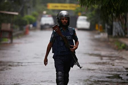 A policeman patrols on the road leading to the Holey Artisan Bakery and the O'Kitchen Restaurant after gunmen attacked, in Dhaka, Bangladesh, July 3, 2016. REUTERS/Adnan Abidi