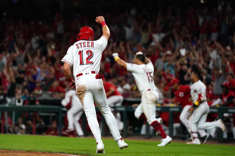 Cincinnati Reds third baseman Spencer Steer (12) celebrates after scoring the game-winning run during the ninth inning of a baseball game against the Colorado Rockies, Friday, Sept. 2, 2022, at Great American Ball Park in Cincinnati. 