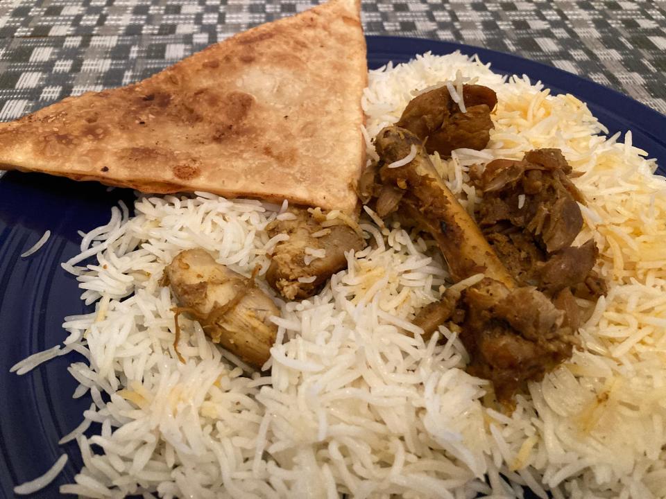 Chicken with rice and bolani (an Afghan flatbread filled with potatoes) from Ariana Natural Market in Essex Junction, shown Nov. 27, 2023.