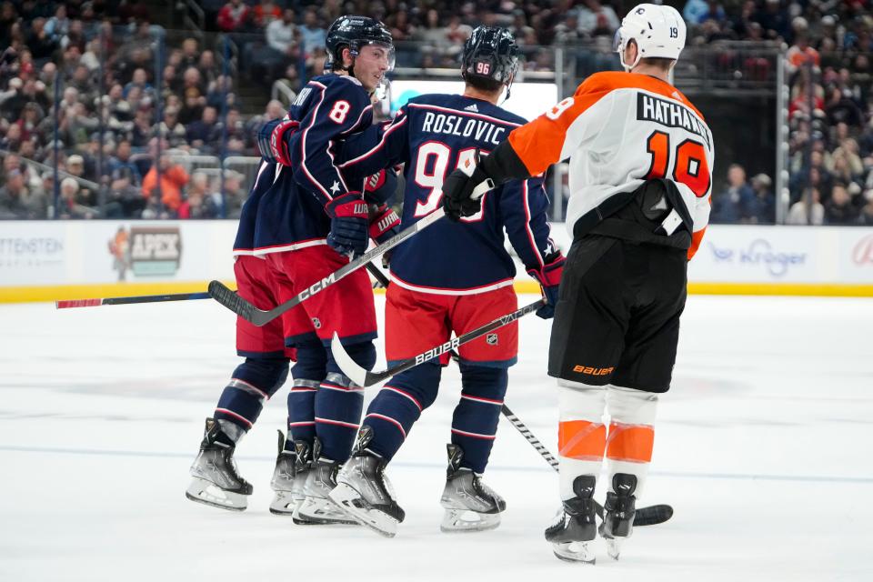 Oct 12, 2023; Columbus, Ohio, USA; Columbus Blue Jackets defenseman Zach Werenski (8) is helped off the ice by Columbus Blue Jackets center Jack Roslovic (96) and center Sean Kuraly (7) after a collision with Philadelphia Flyers right wing Garnet Hathaway (19) during the second period of the NHL hockey game at Nationwide Arena.