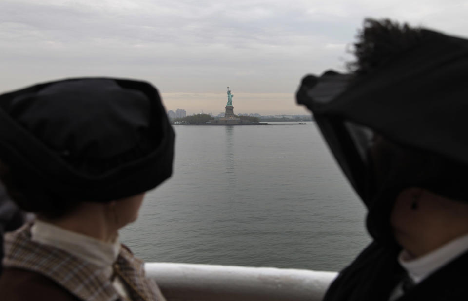 Backdropped by the Statue of Liberty, passengers Maurine Beechler, right, and her daughter my Marie Beechler, both from Buffalo, NY, pause as the MS Balmoral Titanic memorial cruise ship, approaches at New York City port, Thursday, April 19, 2012. Exactly 100 years after the Titanic went down, the cruise retraced the ship's voyage, departing from Southampton, England, included a visit Sunday, April 15, to the location where it sank, then a stop in Halifax, Canada and final destination at New York, as of the original intended trip. (AP Photo/Lefteris Pitarakis)