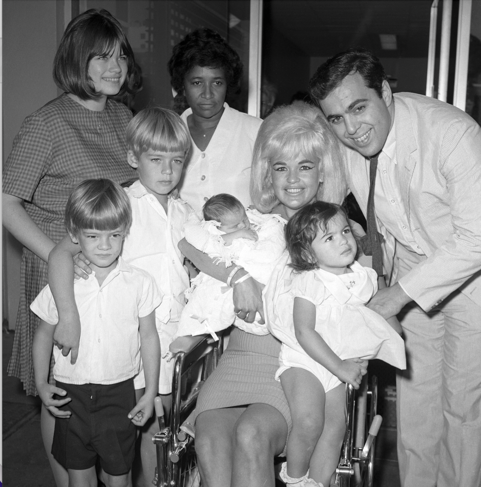 actress jayne mansfield and family are pictured here as the blonde actress leaves cedars of lebanon hospital with the newest addition to the family, baby anthony left to right are jayne marie mansfield, 15, zoltan hargitay, 5, mickey hargitay jr, 6, unidentified hospital attendant, jayne holding baby anthony, and husband matt cimber with mariska hargitay, 1