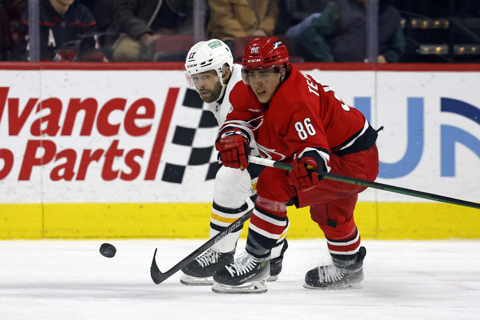 Carolina Hurricanes' Teuvo Teravainen (86) and Pittsburgh Penguins' Bryan Rust (17) compete for the puck during the second period of an NHL hockey game in Raleigh, N.C., Saturday, Jan. 13, 2024. (AP Photo/Karl B DeBlaker)