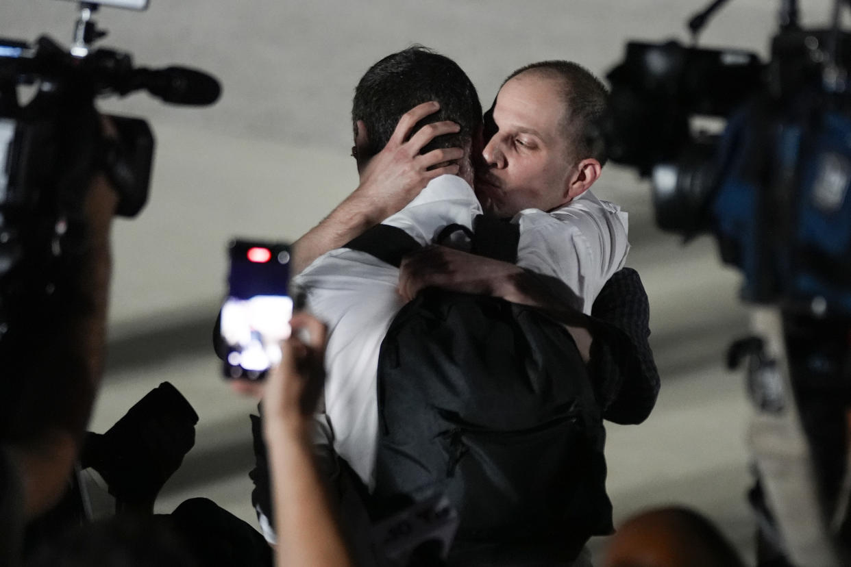 Reporter Evan Gershkovich receives an embrace following his release.