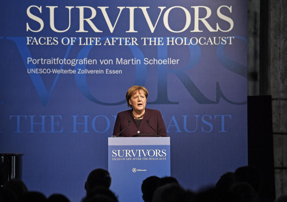 German chancellor Angela Merkel delivers a speech during the opening of the exhibition 'Survivors - Faces of Life after the Holocaust' at the former coal mine Zollverein in Essen, Germany, Tuesday, Jan. 21, 2020. The world heritage landmark Zollverein shows 75 years after the liberation of the Nazi death camp Auschwitz-Birkenau, 75 portraits of Jewish survivors, photographed in Israel by German artist Martin Schoeller. (AP Photo/Martin Meissner)