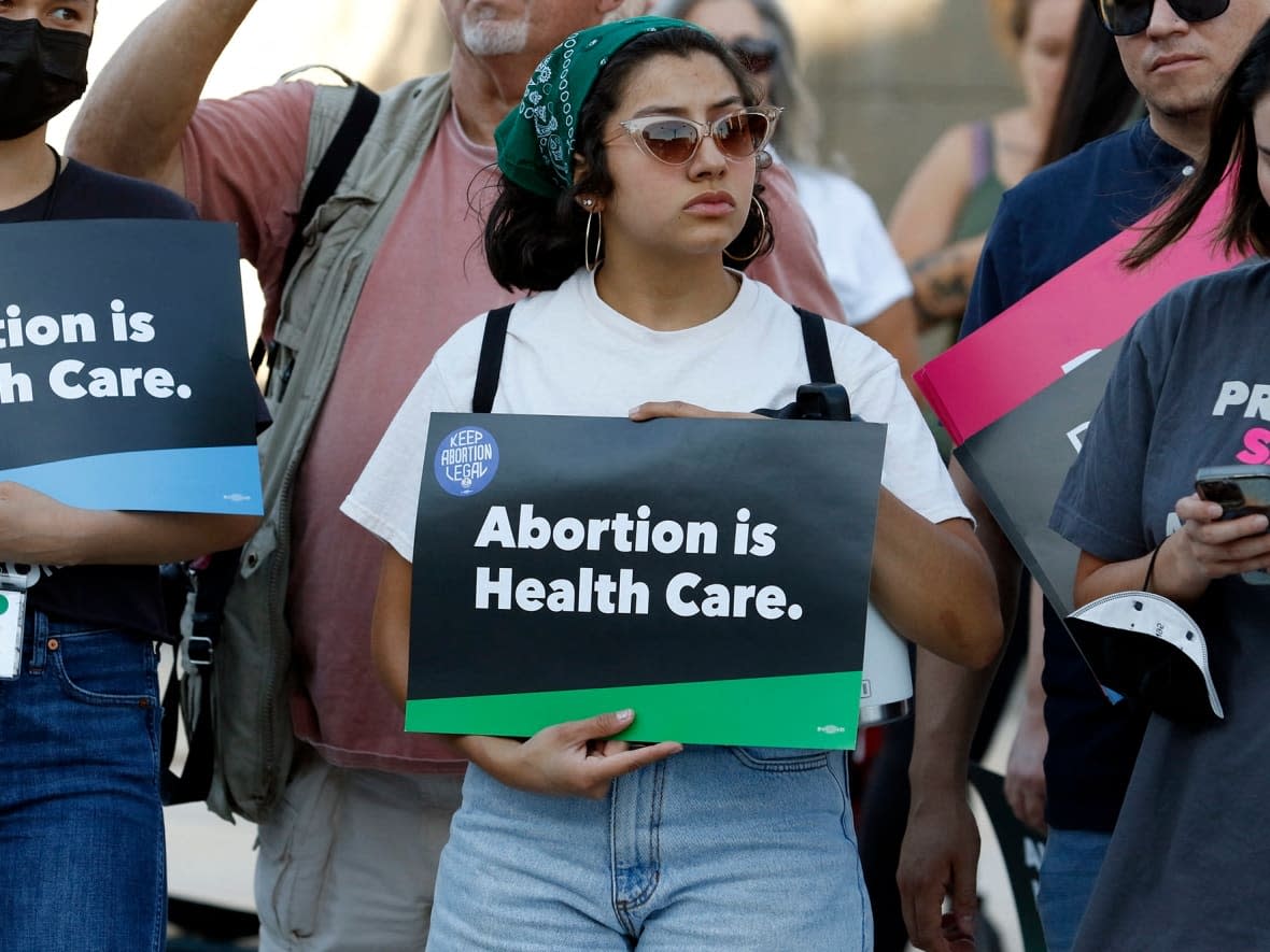 A woman holds an 'Abortion is Health Care' sign as abortion rights activists rally in Las Vegas, Nev., on June 24, 2022. A number of advocates are pushing for changes in the language used as part of abortion care. (Ronda Churchill/AFP/Getty Images - image credit)