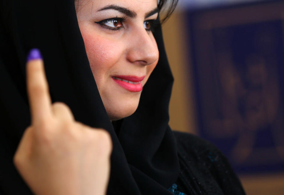 An Iraqi Kurdish woman shows her ink-stained finger after casting her vote at a polling station in Irbil, north of Baghdad, Iraq, Wednesday, April 30, 2014. Iraq is holding its third parliamentary elections since the U.S.-led invasion that toppled dictator Saddam Hussein. More than 22 million voters are eligible to cast their ballots to choose 328 lawmakers out of more than 9,000 candidates. (AP Photo)