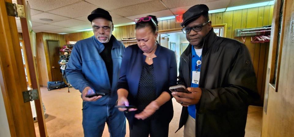 Deacon William Dancy with St. Ashworth Temple Church of God in Christ, Akron NAACP President Judi Hill and Kevin DeJournett watch the Facebook Live announcement Monday about the special grand jury decision in the Jayland Walker case.