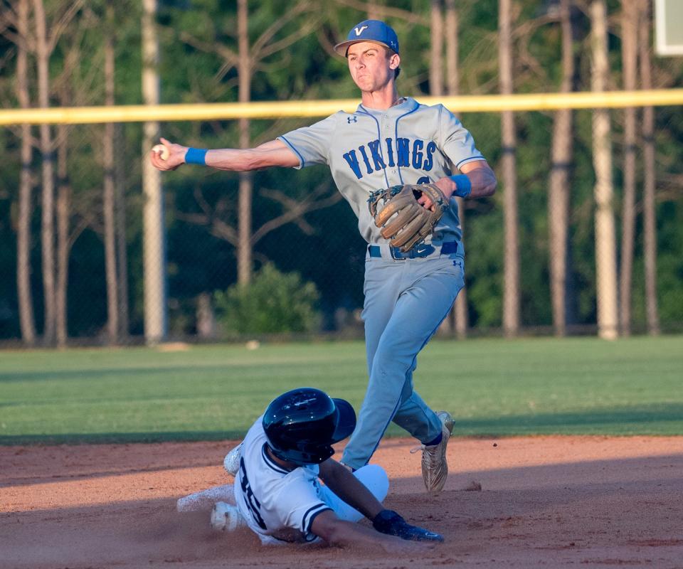 Lakeland Christian second baseman Colby Brewington makes the throw to first base after forcing out McKeel's Jorge Cordova at second on Friday in the championship game of the Polk County Baseball Tournament.