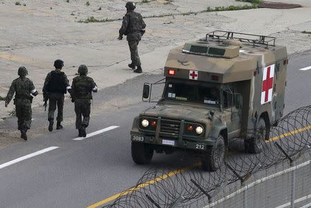 A military ambulance transporting a conscript soldier who shot and killed five comrades, travels to a hospital in Goseong June 23, 2014. REUTERS/Han Jae-ho/News1