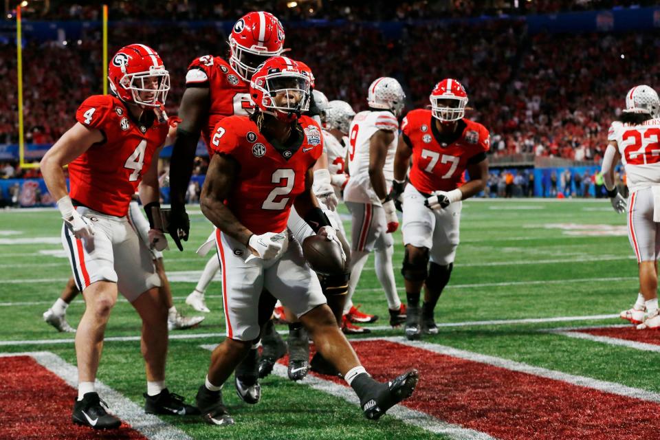Georgia running back Kendall Milton (2) celebrates after scoring a touchdown in the first half against Ohio State during the 2022 Peach Bowl on New Year's Eve.