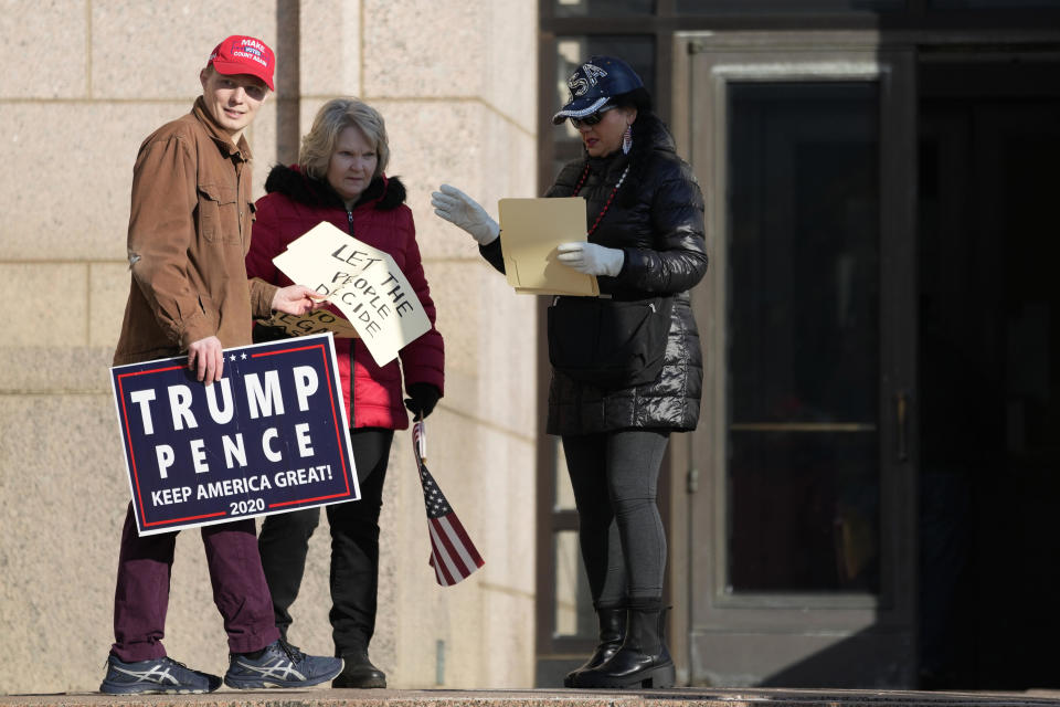 Trump supporters hold signs outside the Minnesota Judicial Center on Thursday, Nov. 2, 2023, in St. Paul, Minnesota. / Credit: Abbie Parr / AP