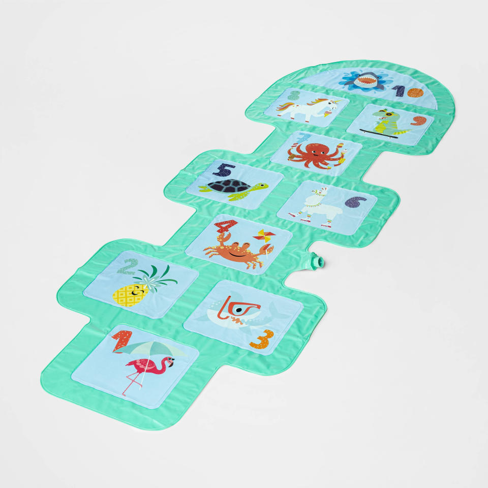 This image provided by Target shows Target's Sun Squad hopscotch sprinkler, that lets out a cool jet of water with every step. It's a backyard summer toy for any age group. (Target via AP)