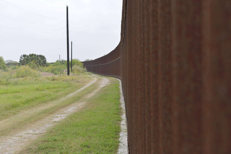 FILE - The U.S. border fence stretches across Rusty Monsees 21.1 acre property on April 30, 2017, in Brownsville, Texas. Gunmen kidnapped four U.S. citizens who crossed into Mexico from Brownsville last week to buy medicine and got caught in a shootout that killed at least one Mexican citizen, U.S. and Mexican officials said Monday, March 6, 2023. (Miguel Roberts/The Brownsville Herald via AP, File)