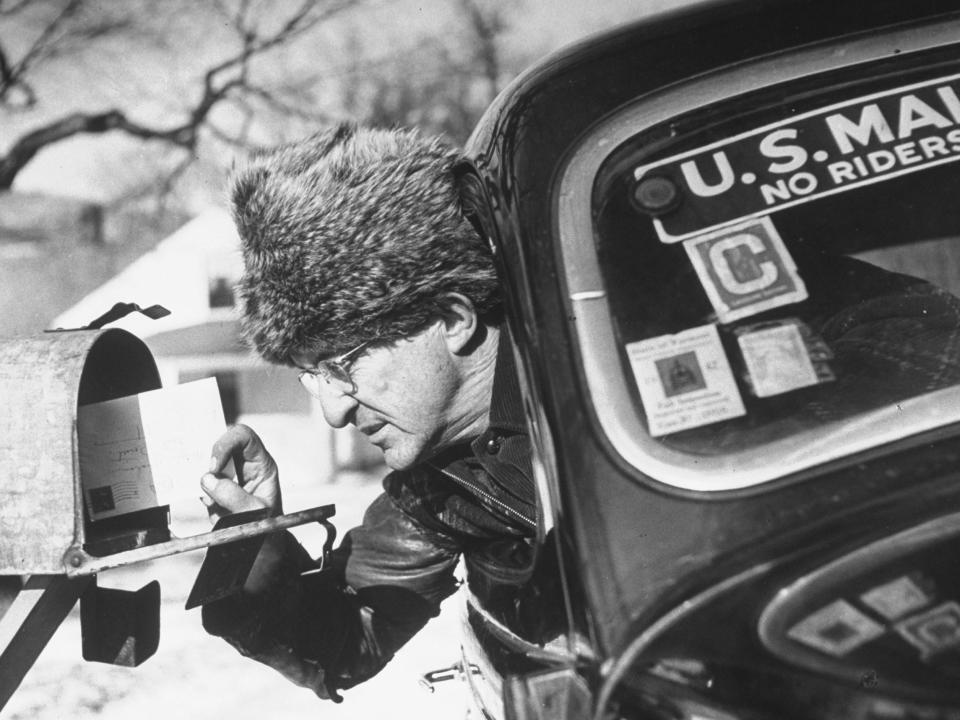 A postal worker wears a fur hat in 1942