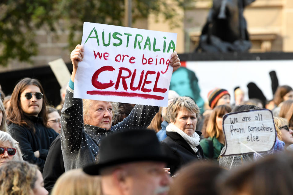 Protesters are seen outside of the State Library of Victoria in Melbourne. Rallies have taken place in Canberra, Sydney, Melbourne, Brisbane marking six years since offshore detention on Manus and Nauru was implemented.