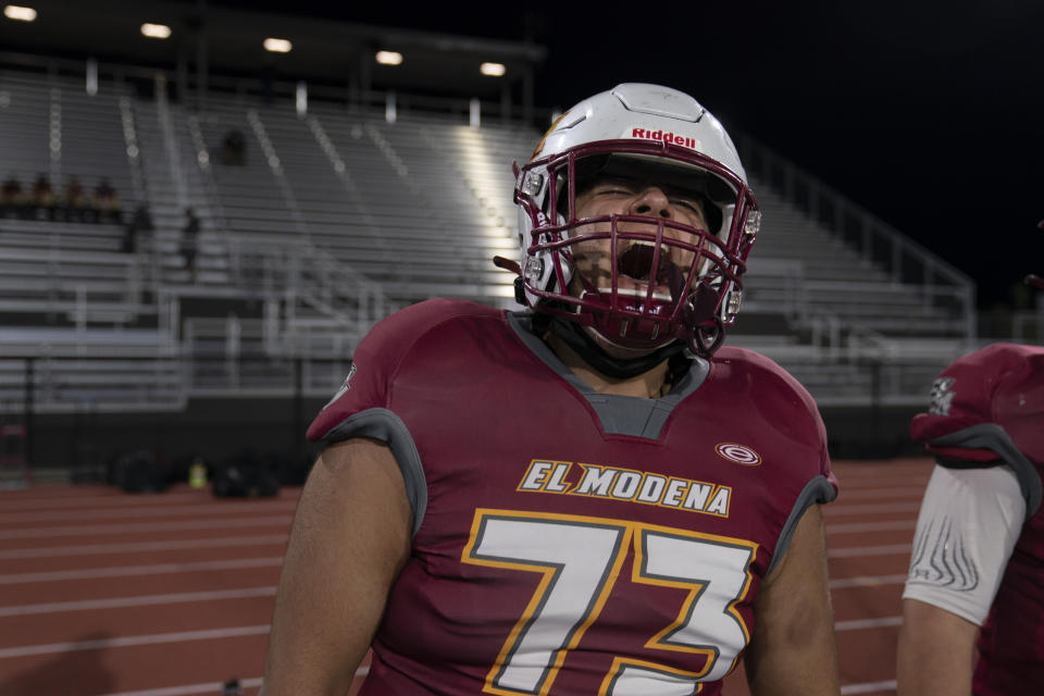 El Modena guard Michael Casares screams to cheer for his teammates during the team's high school football game with El Dorado, in Orange, Calif., Friday, March 19, 2021. (AP Photo/Jae C. Hong)