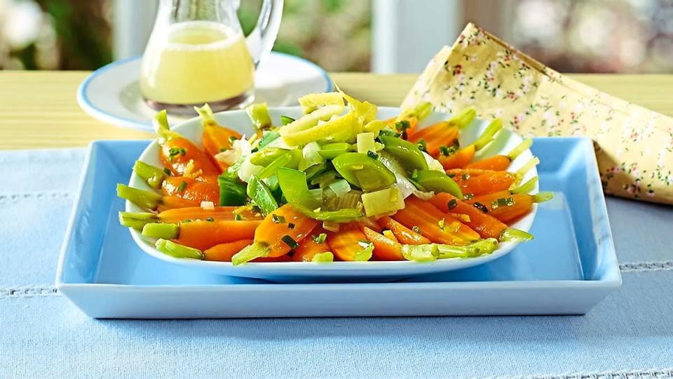 Honeyed Carrots and Leeks sits on a blue bowl (Side dishes for meatloaf)