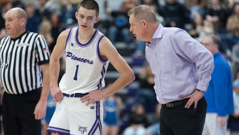 Lehi’s Cooper Lewis, left, listens to his father, coach Quincy Lewis, during a game against Pleasant Grove at Lehi High in Lehi on Friday, Jan. 26, 2024. Lehi won 77-61.