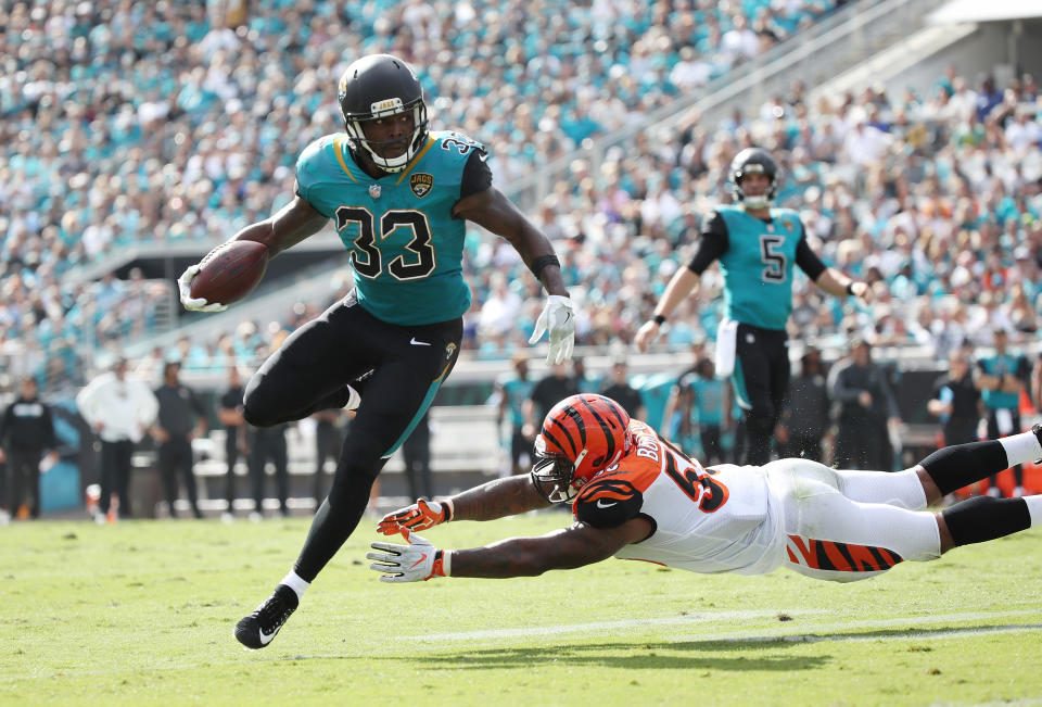 <p>Chris Ivory #33 of the Jacksonville Jaguars runs with the football over Vontaze Burfict #55 of the Cincinnati Bengals during the first half of their game at EverBank Field on November 5, 2017 in Jacksonville, Florida. (Photo by Logan Bowles/Getty Images) </p>