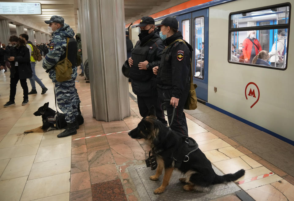Police officers wearing face masks to help curb the spread of the coronavirus patrol a metro (subway) station in Moscow, Russia, Thursday, Nov. 4, 2021. The Moscow authorities banned their traditional "Russian March" in Moscow celebrating People's Unity Day due to the COVID-19 pandemic. AP Photo/Alexander Zemlianichenko)