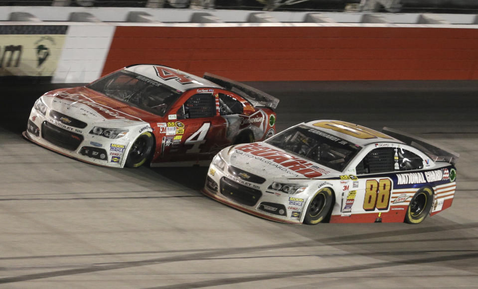 Kevin Harvick (4) passes Dale Earnhardt Jr (88) in Turn 4 on the next-to-last lap during the NASCAR Sprint Cup auto race at Darlington Raceway in Darlington, S.C., Saturday, April 12, 2014. Harvick won the race. (AP Photo/Chuck Burton)