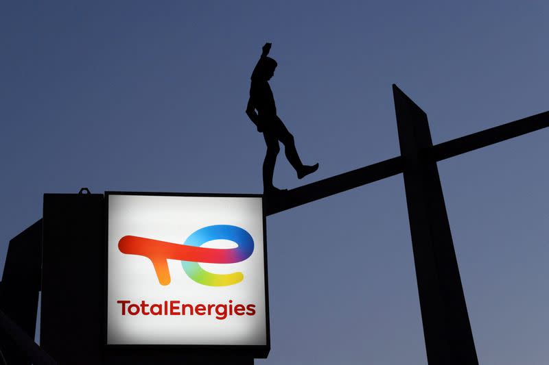 FILE PHOTO: A TotalEnergies logo on a display at a fuel station in Berlin