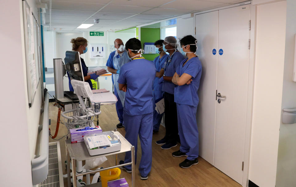 Staff gather for a briefing on a COVID-19 recovery ward at Wexham Park Hospital near Slough, May 22, 2020. Steve Parsons/Pool via REUTERS