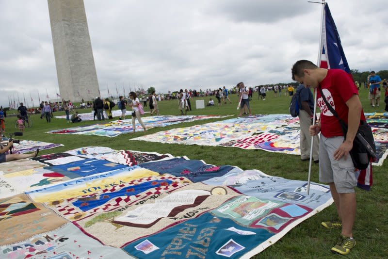 A man photographs a portion of the AIDS quilt during the Keep the Promise on HIV/AIDS rally celebrating the opening of the International AIDS Conference on the National Mall on July 22, 2012, in Washington, D.C. On March 20, 1987, the U.S. government approved the sale of AZT, a treatment, but not a cure, for AIDS. File Photo by Kevin Dietsch/UPI