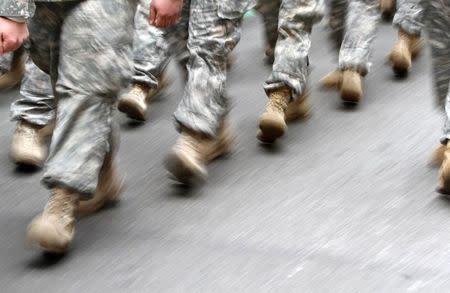 U.S. army soldiers are seen marching in the St. Patrick's Day Parade in New York, March 16, 2013. REUTERS/Carlo Allegri