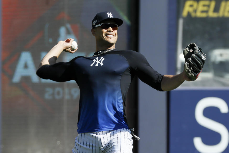 New York Yankees left fielder Giancarlo Stanton throws in the outfield before Game 3 of baseball's American League Championship Series against the Houston Astros, Tuesday, Oct. 15, 2019, in New York. (AP Photo/Matt Slocum)