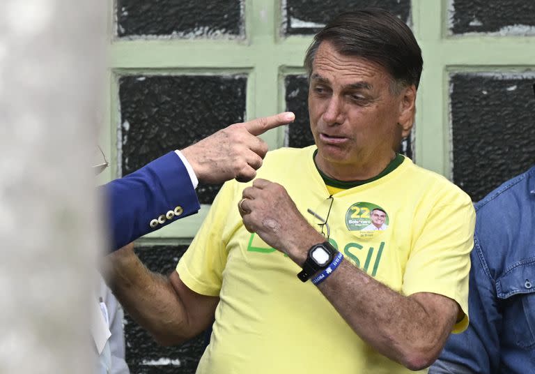 El presidente brasileño y candidato a la reelección, Jair Bolsonaro en un gesto inusual antes de votar en un colegio en Río de Janeiro, Brasil, el 30 de octubre de 2022, durante la segunda vuelta de las elecciones presidenciales.