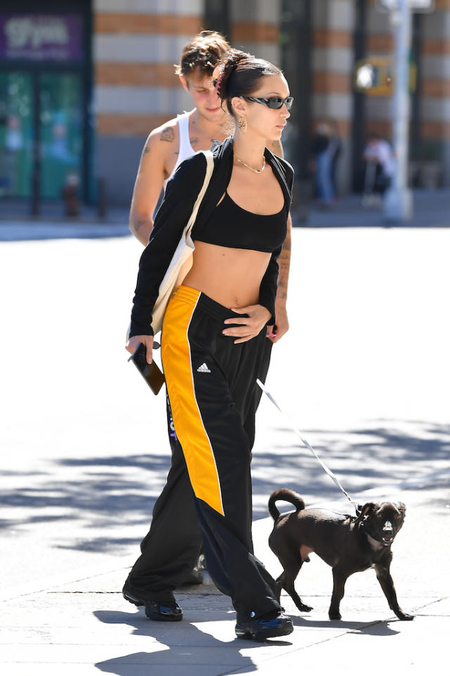 Bella Hadid Goes Sporty-Chic in Distressed Crewneck, Sleek Sweatpants &  Shiny Sneakers in New York City