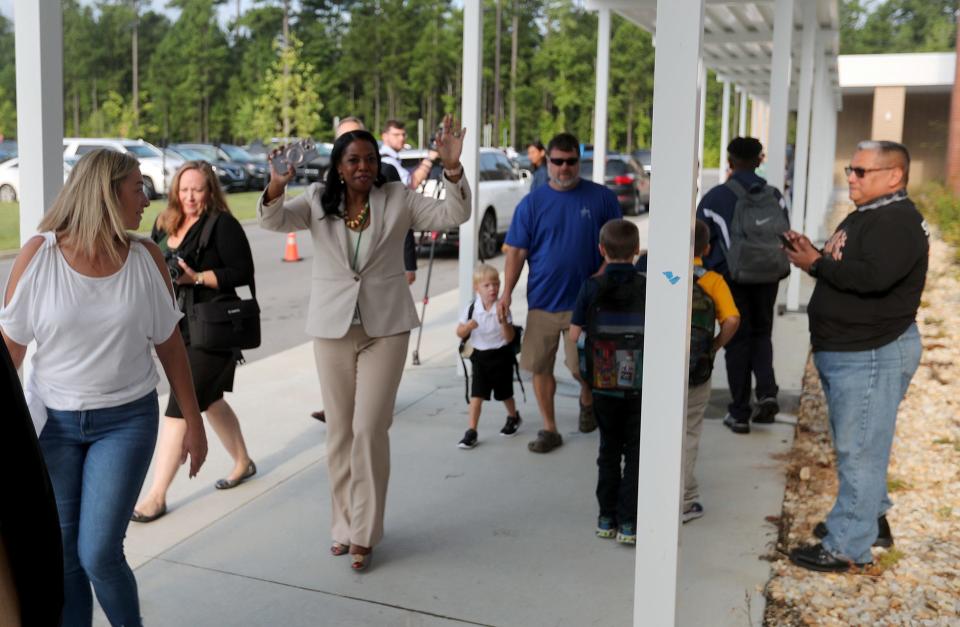 Superintendent Denise Watts waves as she arrives at New Hampstead K-8 for the first day of school on Thursday, August 3, 2023.