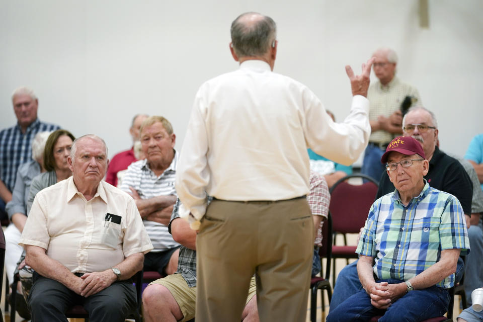 In this June 30, 2021, photo Local residents listen as Sen. Chuck Grassley, R-Iowa, center, speaks during a town hall meeting in Ida Grove, Iowa. (AP Photo/Charlie Neibergall)