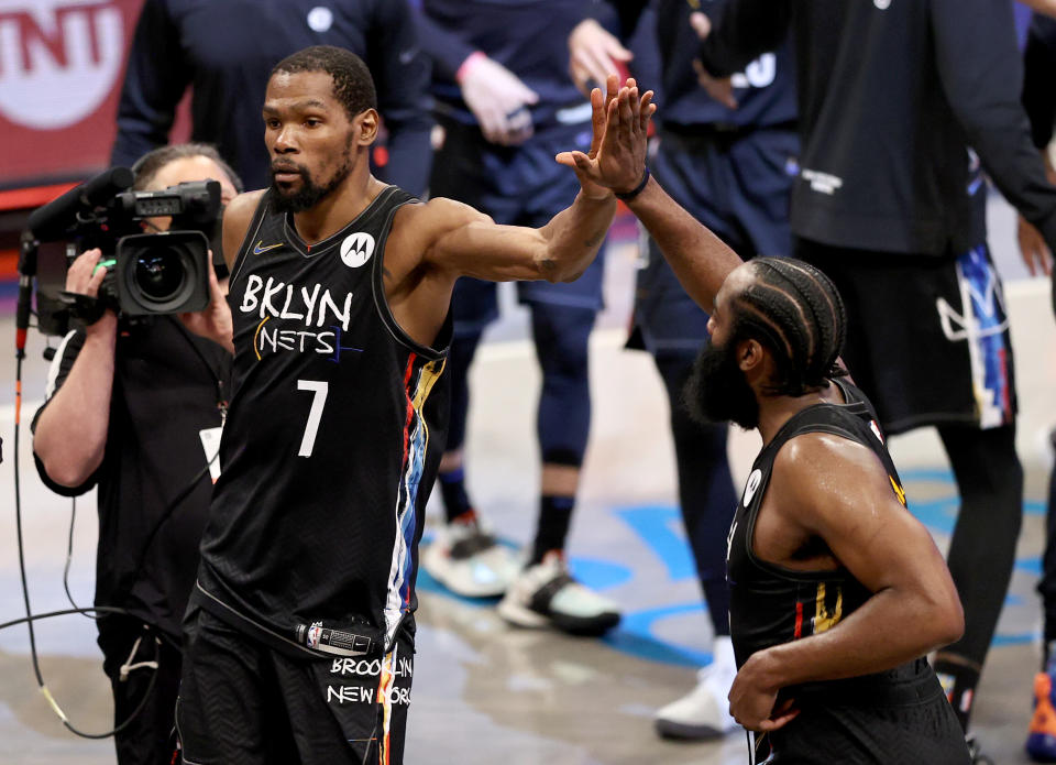 Kevin Durant #7 and James Harden #13 of the Brooklyn Nets celebrate the win after the game against the Milwaukee Bucks during game 5 of the Eastern Conference second round at Barclays Center on June 15, 2021 in the Brooklyn borough of New York City. The Brooklyn Nets defeated the Milwaukee Bucks 114-108. NOTE TO USER: User expressly acknowledges and agrees that, by downloading and or using this photograph, User is consenting to the terms and conditions of the Getty Images License Agreement. (Photo by Elsa/Getty Images)