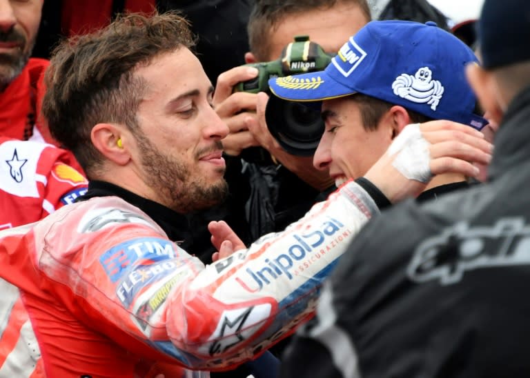 Ducati rider Andrea Dovizioso of Italy (L) is congraturated by Honda rider Marc Marquez of Spain at the parc ferme during the MotoGP Japanese Grand Prix, at Twin Ring Motegi circuit in Motegi, Tochigi prefecture, on October 15, 2017