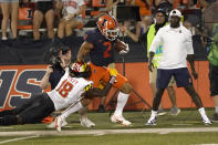 Illinois running back Chase Brown (2) is tackled out of bounds by Maryland defensive back Jordan Mosley (18) off a pass from quarterback Brandon Peters during the first half of an NCAA college football game Friday, Sept. 17, 2021, in Champaign, Ill. (AP Photo/Charles Rex Arbogast)