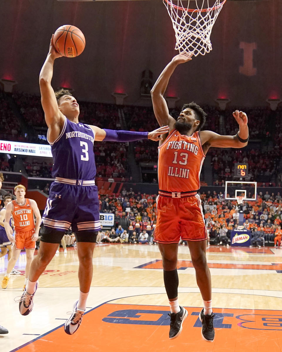 Northwestern's Ty Berry (3) shoots as Illinois' Quincy Guerrier defends during the first half of an NCAA college basketball game Tuesday, Jan. 2, 2024, in Champaign, Ill. (AP Photo/Charles Rex Arbogast)