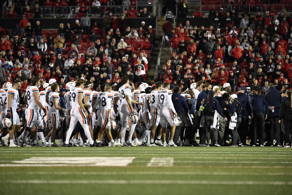 The Virginia football team goes to show their support of teammate running back Perris Jones (2) during the second half of an NCAA college football game in Louisville, Ky., Thursday, Nov. 9, 2023. (AP Photo/Timothy D. Easley)