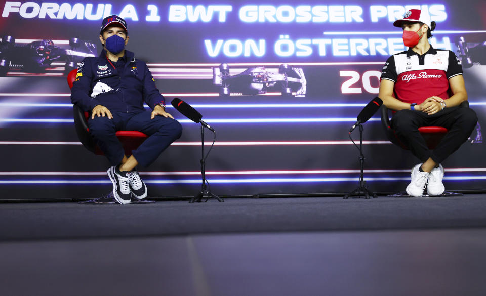 Red Bull driver Sergio Perez of Mexico, left, and Alfa Romeo driver Antonio Giovinazzi of Italy attend a media conference ahead of the Austrian Formula One Grand Prix at the Red Bull Ring racetrack in Spielberg, Austria, Thursday, July 1, 2021. (Dan Istitene/Pool Photo via AP)