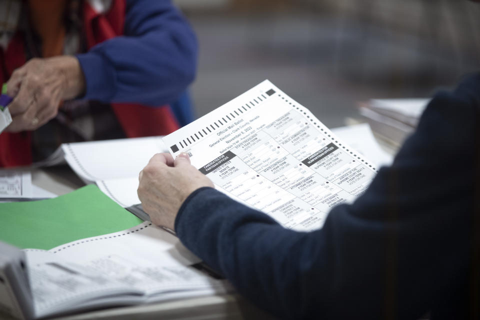 Election workers inspect mail-in ballots in the count room at the Clark County Election Department in North Las Vegas, Saturday, Nov. 12, 2022. Nevada's ballot count is entering its final act and may determine which party controls the U.S. Senate. (Steve Marcus/Las Vegas Sun via AP)