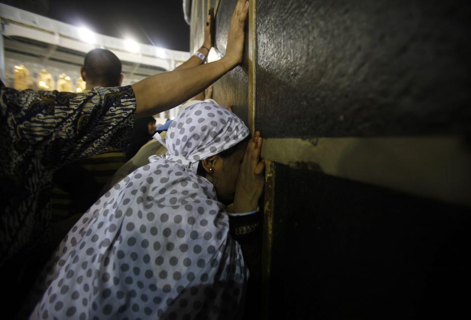 Muslim pilgrims touch the Kaaba at the Grand Mosque in the holy city of Mecca ahead of the annual Haj pilgrimage