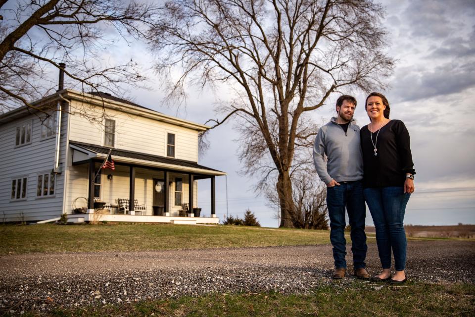 Kelly and Katie Grove stand for a photo at their home near Alleman on Tuesday, April 12, 2022. They worry that if their home becomes part of Ankeny they will have to spend up to $100,000 to replace their gravel driveway with concrete.