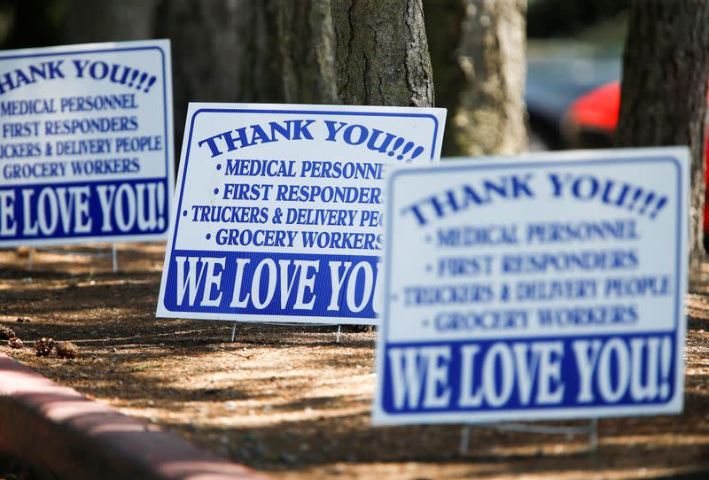 Signs outside Life Care Center of Kirkland, a long-term care facility linked to several coronavirus disease (COVID-19) deaths in Kirkland