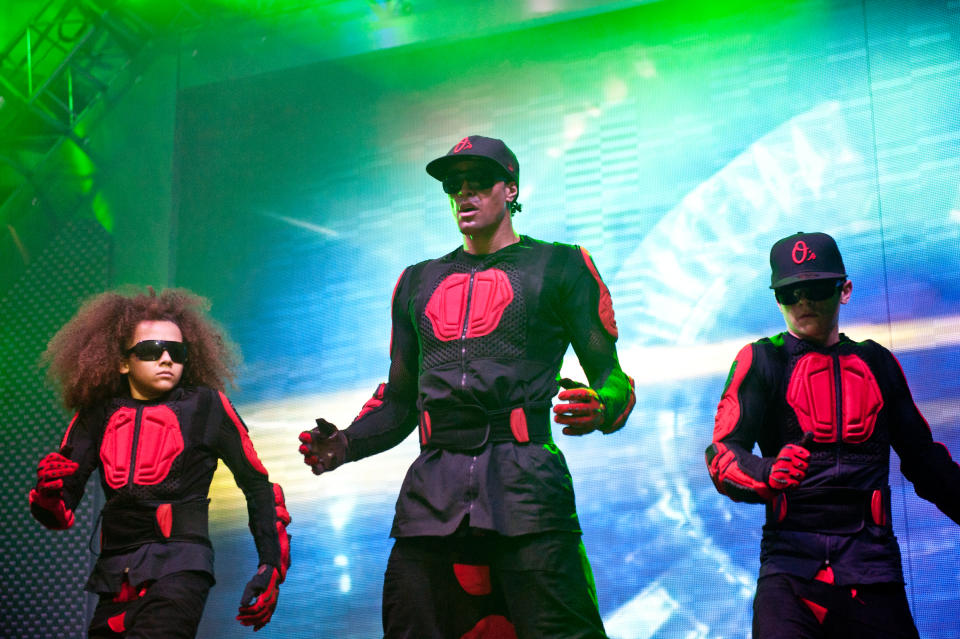 NOTTINGHAM, UNITED KINGDOM - APRIL 03:  (EXCLUSIVE COVERAGE) Perri Luc Kiely, Ashley Banjo and Mitchell Craske of Diversity perform during the 2012 Digitized: In a Game Tour on stage at Nottingham Capital FM Arena on April 3, 2012 in Nottingham, United Kingdom. (Photo by Ollie Millington/Redferns via Getty Images)