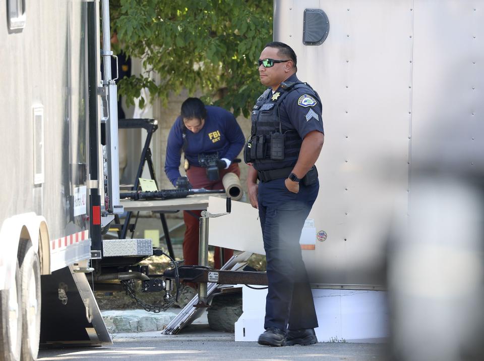Law enforcement agents investigate at the home of Craig Deeleuw Robertson who was shot and killed by FBI agents in Provo on Wednesday, Aug. 9, 2023. Robertson posted threatening comments about President Joe Biden hours before the president was scheduled to visit Utah. | Laura Seitz, Deseret News