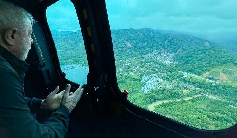 Brazil's President Luiz Inacio Lula da Silva flies in a helicopter over affected areas after torrential rain caused flooding and landslides in Sao Sebastiao